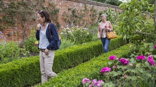 Visitors in the walled Rose Garden at Mottisfont, Hampshire